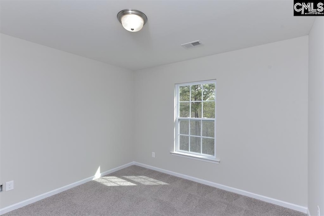 empty room with carpet, baseboards, and visible vents