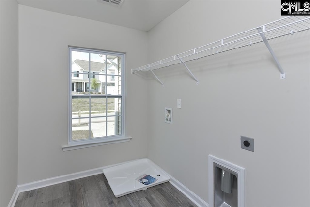 clothes washing area featuring hookup for a washing machine, laundry area, baseboards, dark wood finished floors, and electric dryer hookup