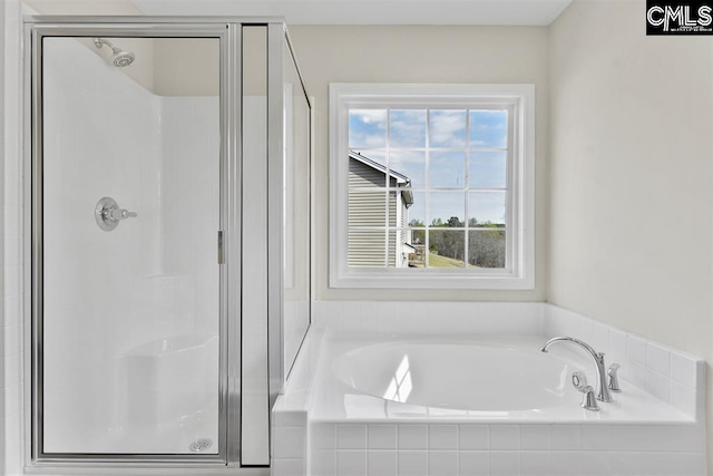 full bathroom featuring a stall shower and a garden tub