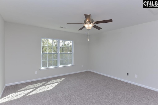 carpeted empty room with ceiling fan, visible vents, and baseboards