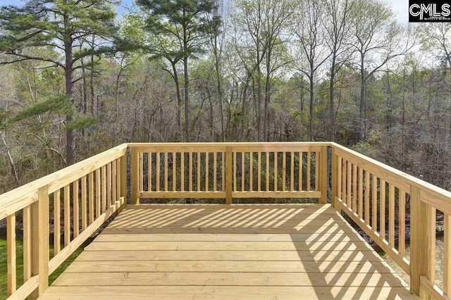 wooden terrace with a view of trees