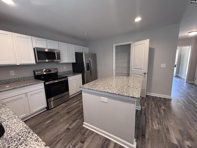 kitchen with stainless steel appliances, a center island, and white cabinetry