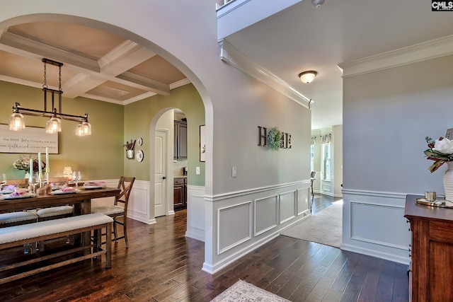 dining room with ornamental molding, coffered ceiling, dark wood finished floors, and beam ceiling