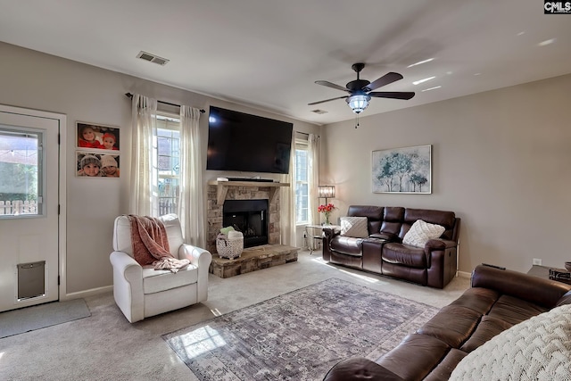 living area with ceiling fan, visible vents, and carpet flooring