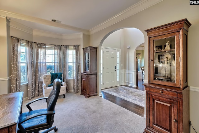 office with visible vents, arched walkways, wainscoting, ornamental molding, and wood finished floors