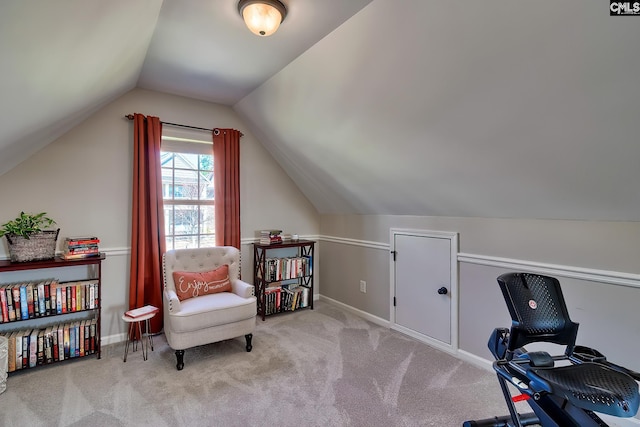 living area featuring lofted ceiling, baseboards, and carpet flooring