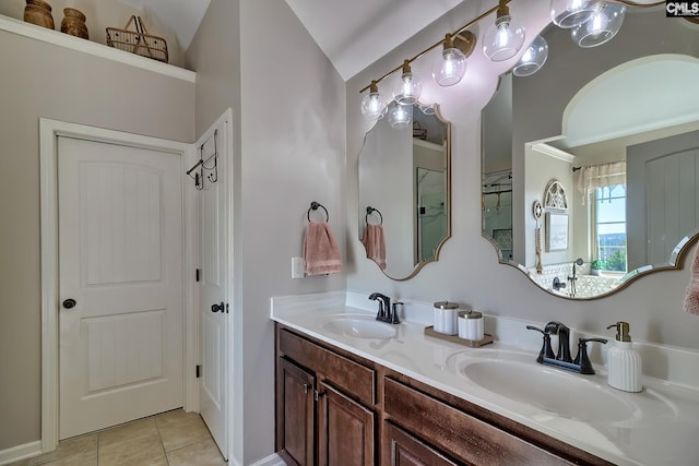 full bath with vaulted ceiling, double vanity, tile patterned flooring, and a sink