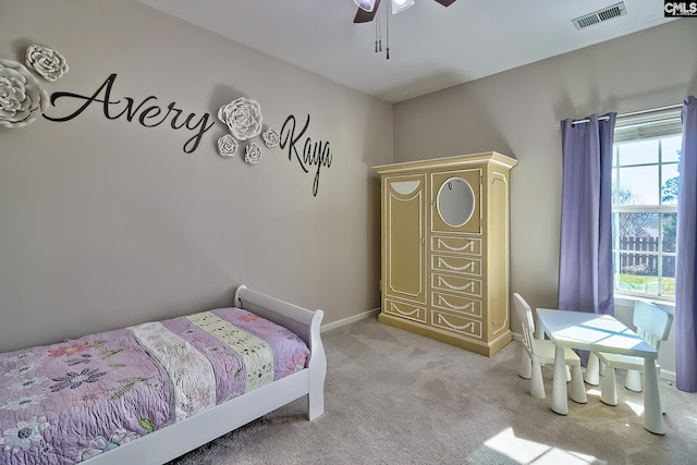 bedroom featuring light carpet, a ceiling fan, visible vents, and baseboards