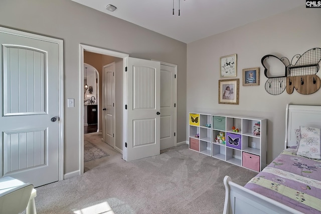 carpeted bedroom featuring baseboards