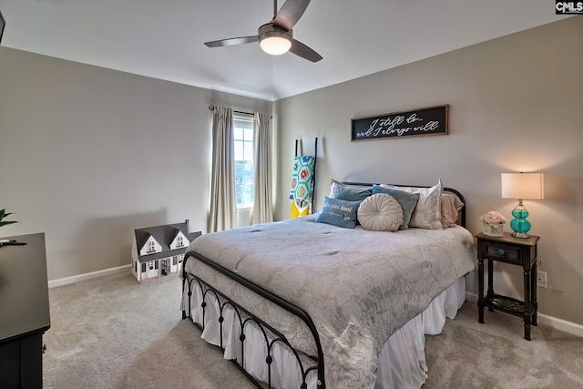 bedroom featuring baseboards, a ceiling fan, and light colored carpet