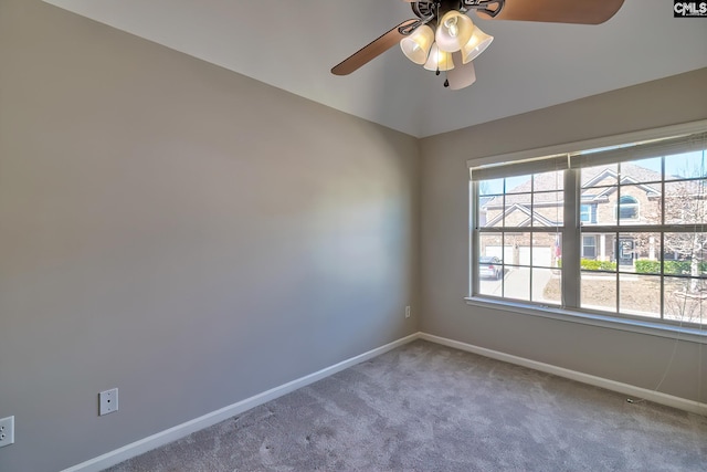 unfurnished room featuring carpet floors, lofted ceiling, ceiling fan, and baseboards