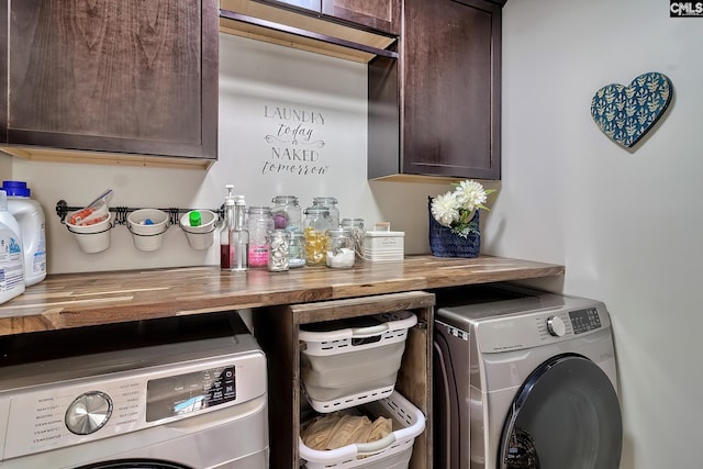 washroom featuring cabinet space and washing machine and dryer