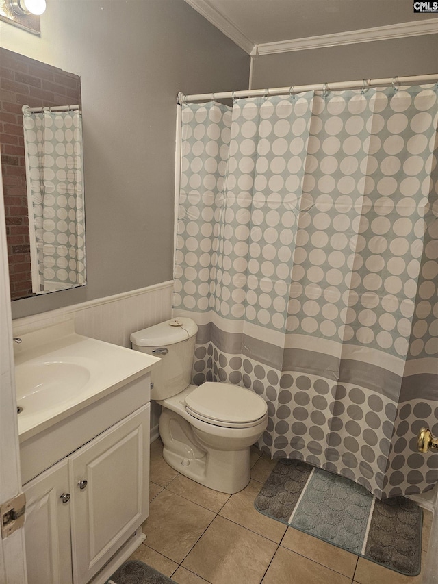 full bath featuring a wainscoted wall, toilet, ornamental molding, vanity, and tile patterned flooring