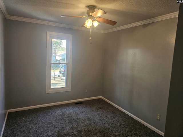 spare room with ornamental molding, dark carpet, and visible vents