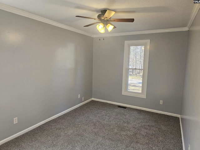 unfurnished room featuring visible vents, baseboards, a ceiling fan, crown molding, and dark carpet