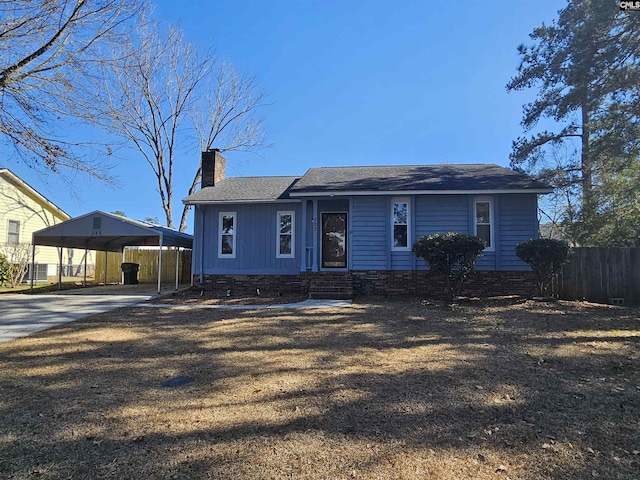 view of front of property with driveway, a chimney, crawl space, fence, and a detached carport