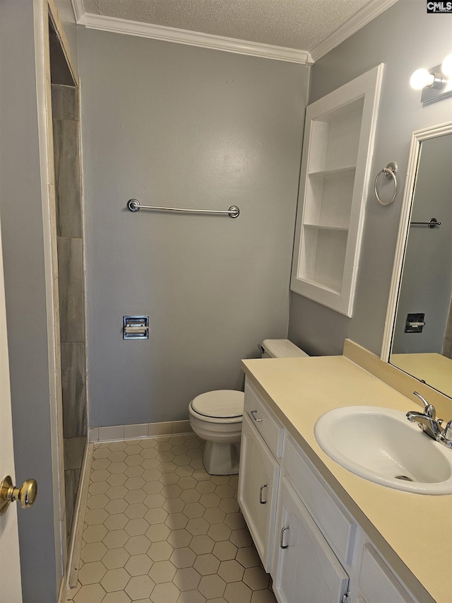 bathroom featuring toilet, vanity, tile patterned floors, a textured ceiling, and crown molding