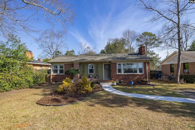 single story home featuring a chimney, a front lawn, cooling unit, and brick siding