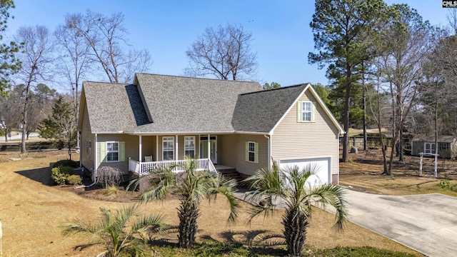 view of front of house with a porch, driveway, a shingled roof, and an attached garage