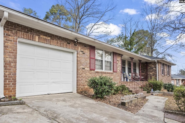 ranch-style house with brick siding, driveway, and an attached garage