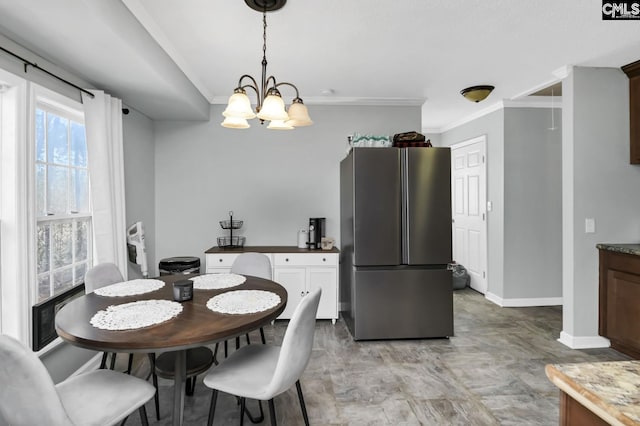 dining space featuring baseboards, ornamental molding, and a chandelier