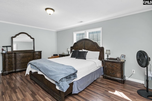 bedroom with dark wood-type flooring, visible vents, ornamental molding, and baseboards