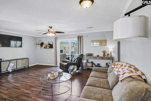 living area featuring a ceiling fan, crown molding, baseboards, and wood finished floors