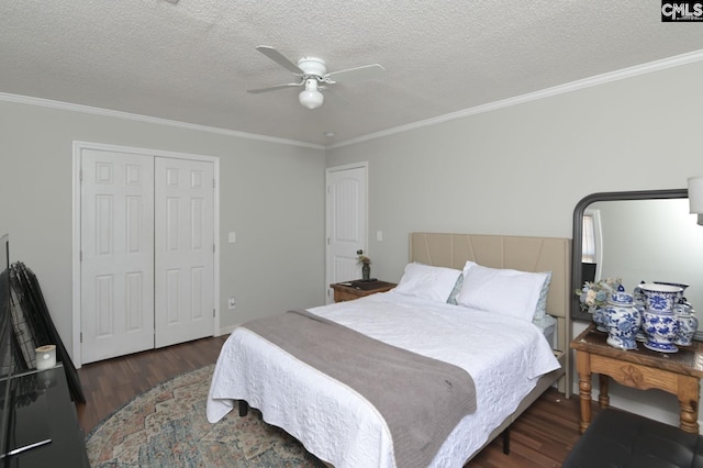 bedroom featuring ornamental molding, a closet, and wood finished floors