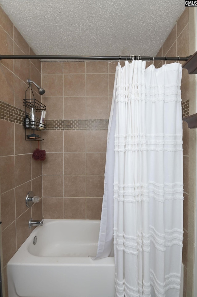 full bath featuring a textured ceiling and shower / tub combo