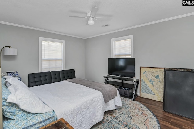 bedroom featuring multiple windows, wood finished floors, visible vents, and crown molding