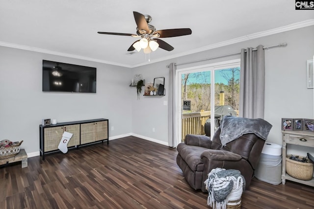 living room featuring ceiling fan, crown molding, baseboards, and wood finished floors