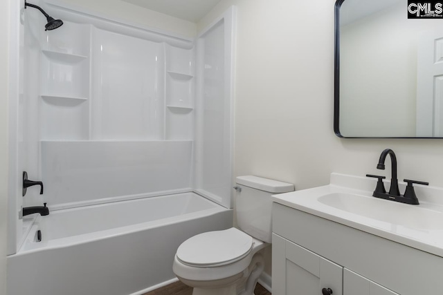 bathroom with shower / washtub combination, vanity, and toilet