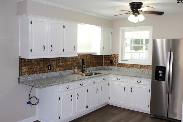 kitchen with tasteful backsplash, white cabinetry, a sink, and stainless steel fridge with ice dispenser