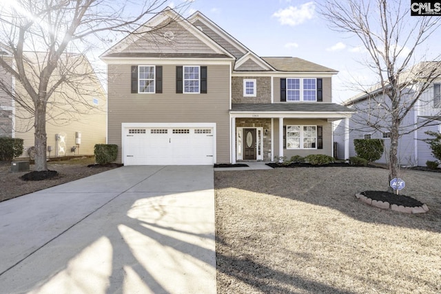 view of front of property with a porch, driveway, and an attached garage