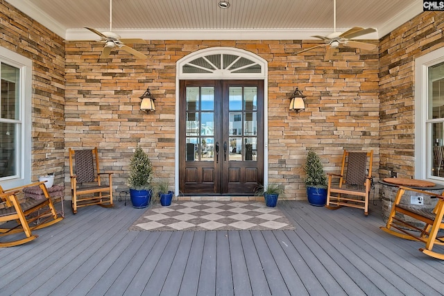 property entrance featuring a ceiling fan and french doors