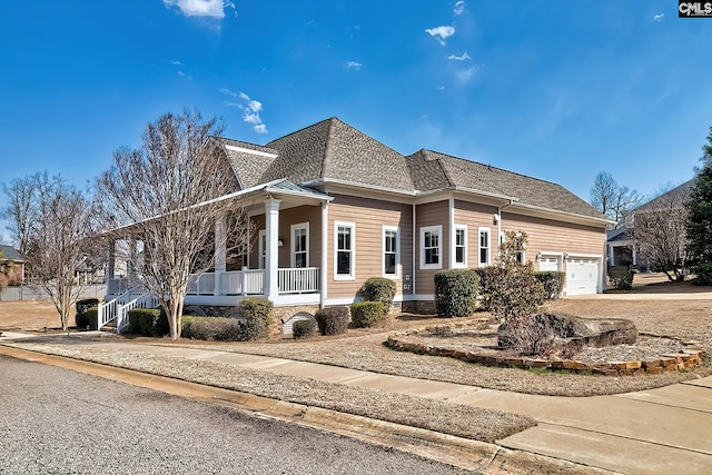 view of front of house featuring covered porch, driveway, and roof with shingles