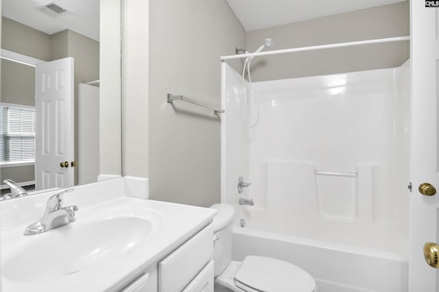 bathroom featuring visible vents, toilet, tub / shower combination, a textured ceiling, and vanity