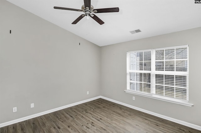 unfurnished room with a ceiling fan, visible vents, baseboards, and wood finished floors