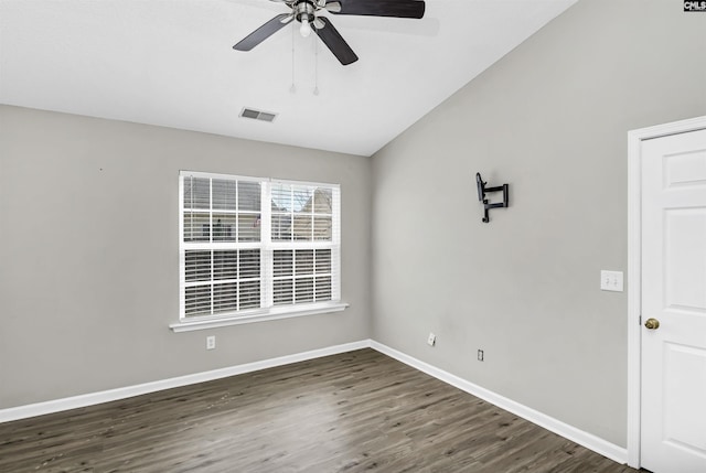 unfurnished room featuring ceiling fan, wood finished floors, visible vents, baseboards, and vaulted ceiling