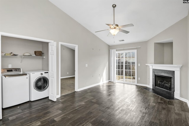 laundry room with laundry area, dark wood-style flooring, a fireplace, a ceiling fan, and washing machine and clothes dryer