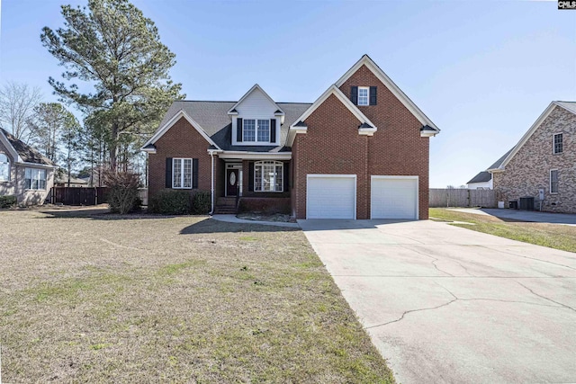 traditional home with a garage, concrete driveway, fence, a front lawn, and brick siding