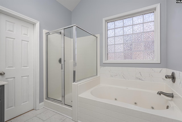 bathroom featuring a stall shower, plenty of natural light, and a tub with jets