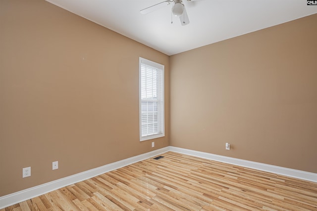 unfurnished room with light wood-style floors, baseboards, and a ceiling fan