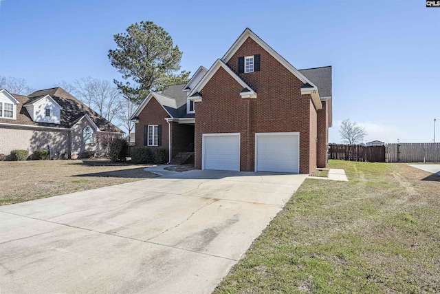 view of front facade with a garage, driveway, brick siding, fence, and a front yard