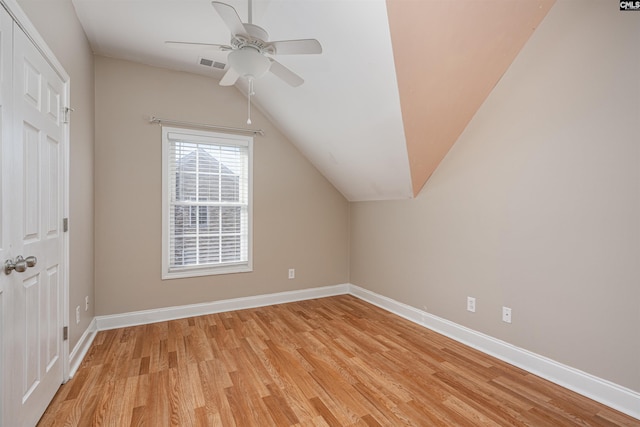 bonus room with baseboards, visible vents, a ceiling fan, lofted ceiling, and light wood-type flooring