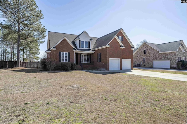 traditional-style home featuring an attached garage, brick siding, fence, concrete driveway, and a front yard