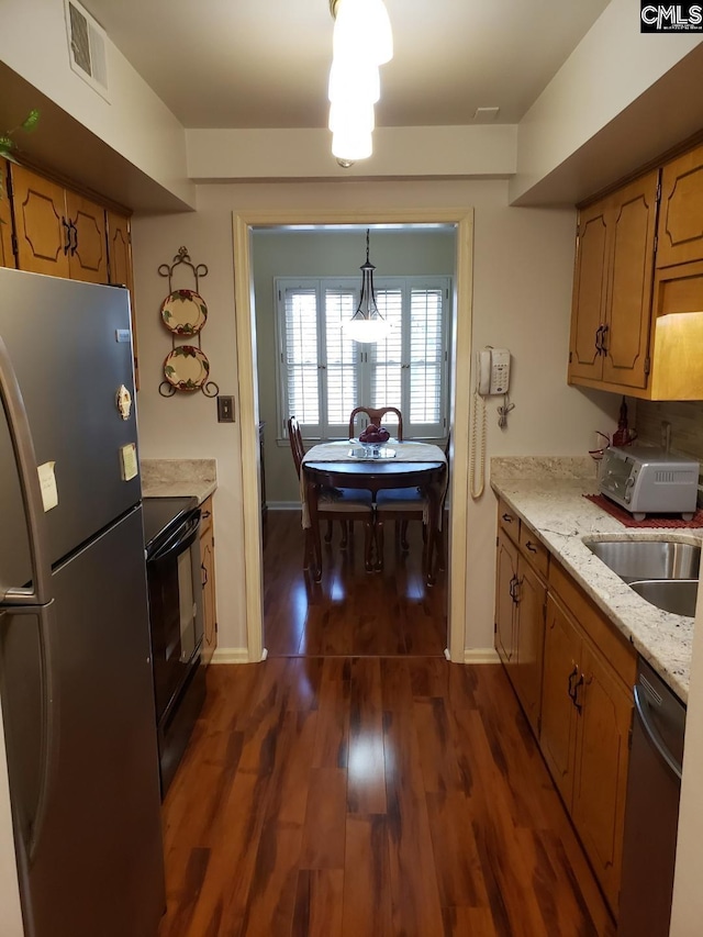 910 Poinsett Pl Unit 5, West Columbia, SC 29169 - kitchen with stainless steel appliances, visible vents, dark wood-type flooring, a sink, and light stone countertops