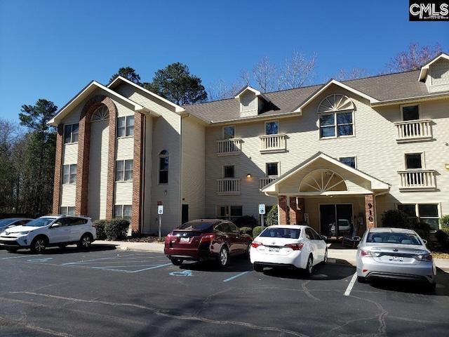 view of property featuring uncovered parking