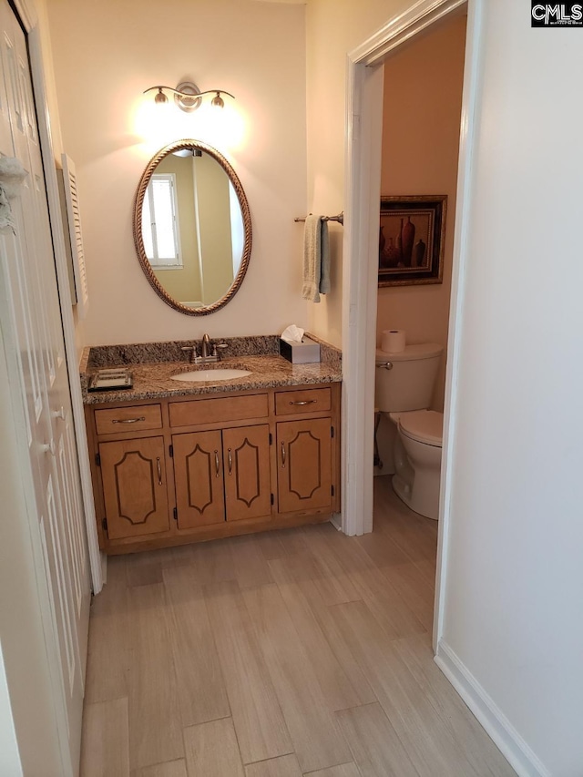 910 Poinsett Pl Unit 5, West Columbia, SC 29169 - bathroom with toilet, baseboards, wood finished floors, and vanity