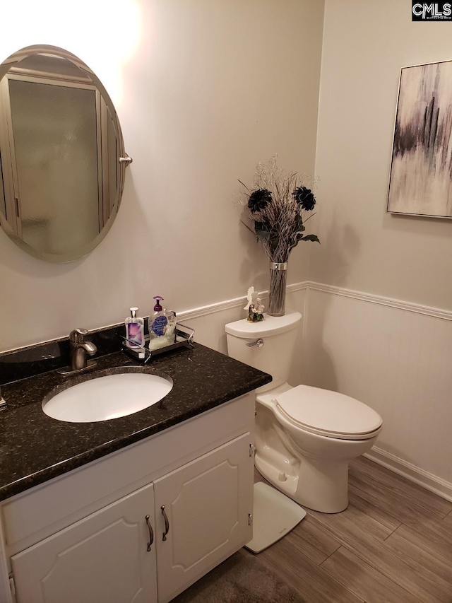 910 Poinsett Pl Unit 5, West Columbia, SC 29169 - half bath featuring toilet, a wainscoted wall, wood finished floors, and vanity
